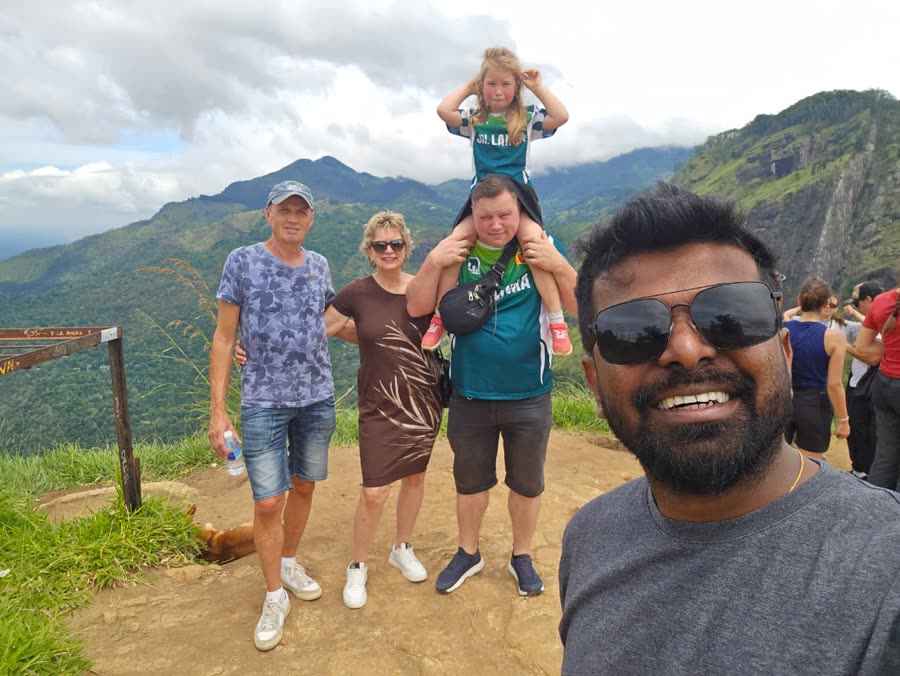 A family with their kids at a hill-country viewpoint