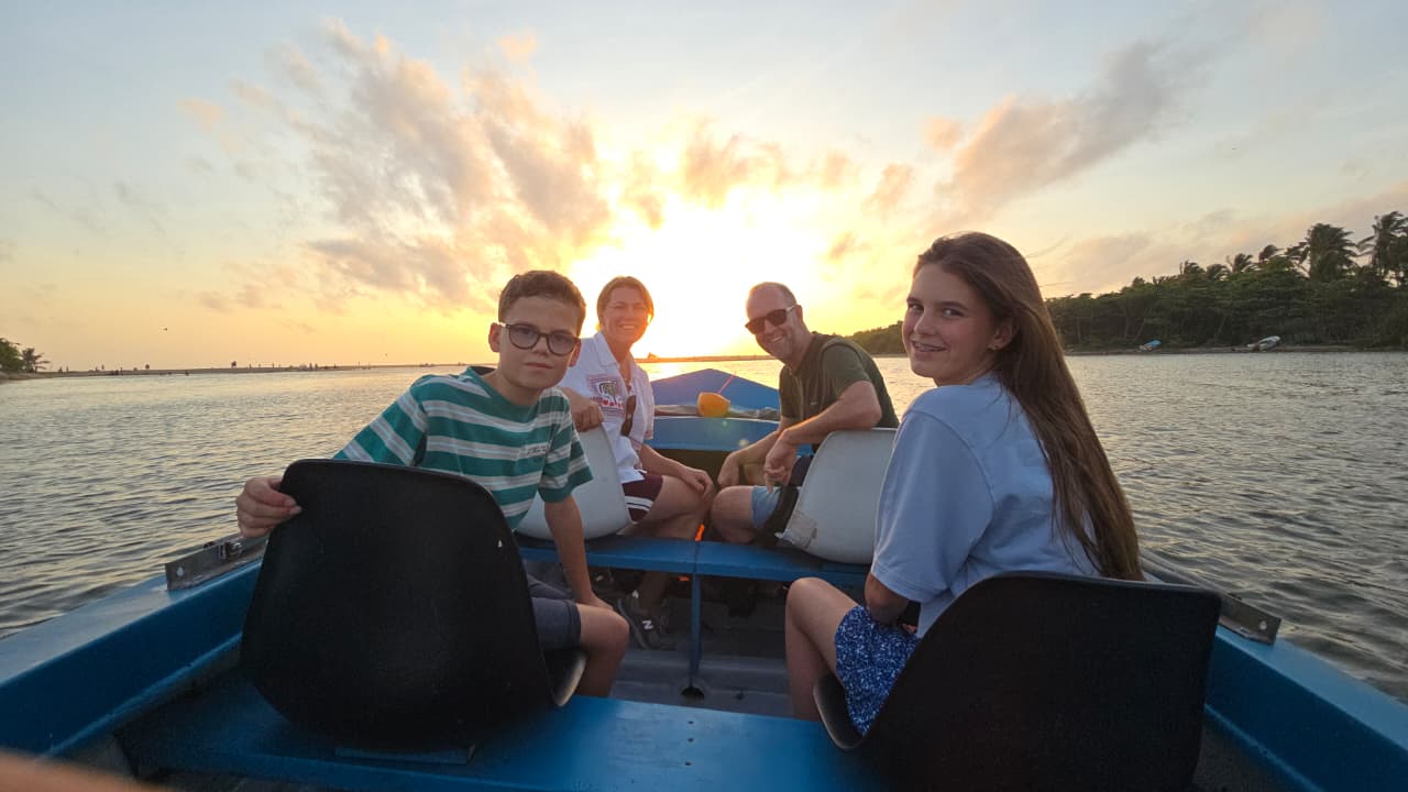 The family on a boat at sunset in Negombo