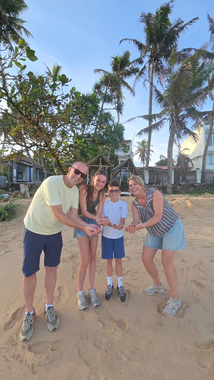 The family on the beach among palm trees