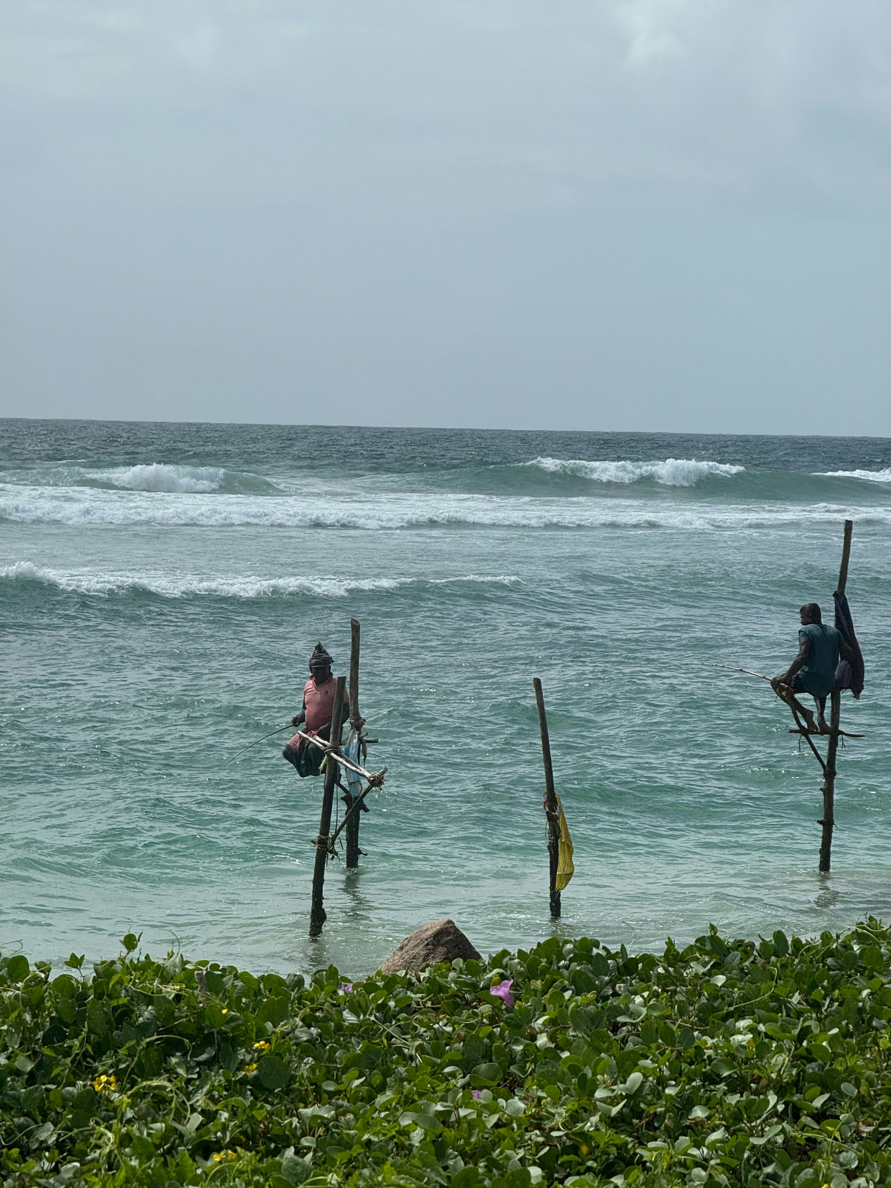 Local fishermen on bamboo stilts at the coast