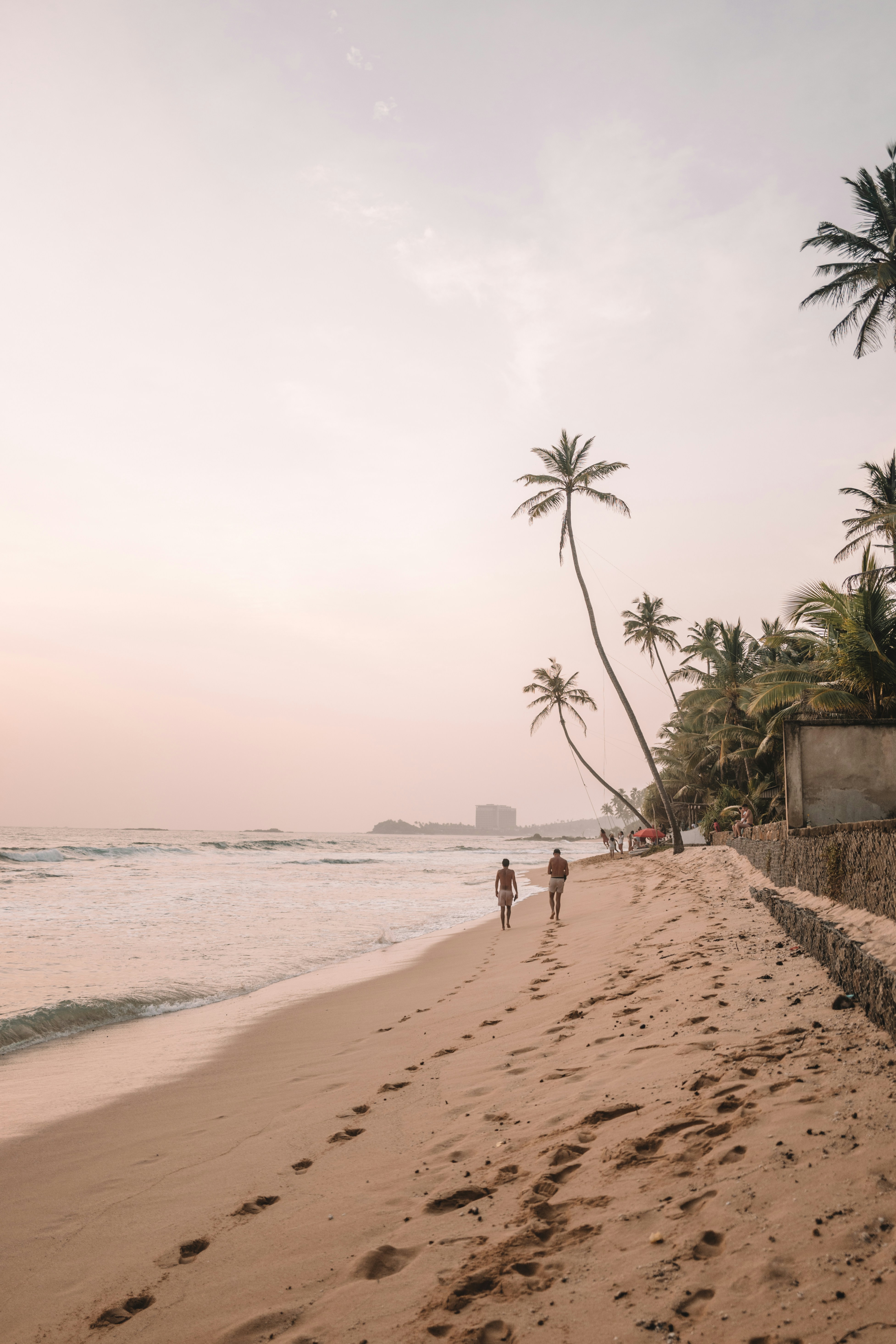Calm crescent of Unawatuna Beach with palms