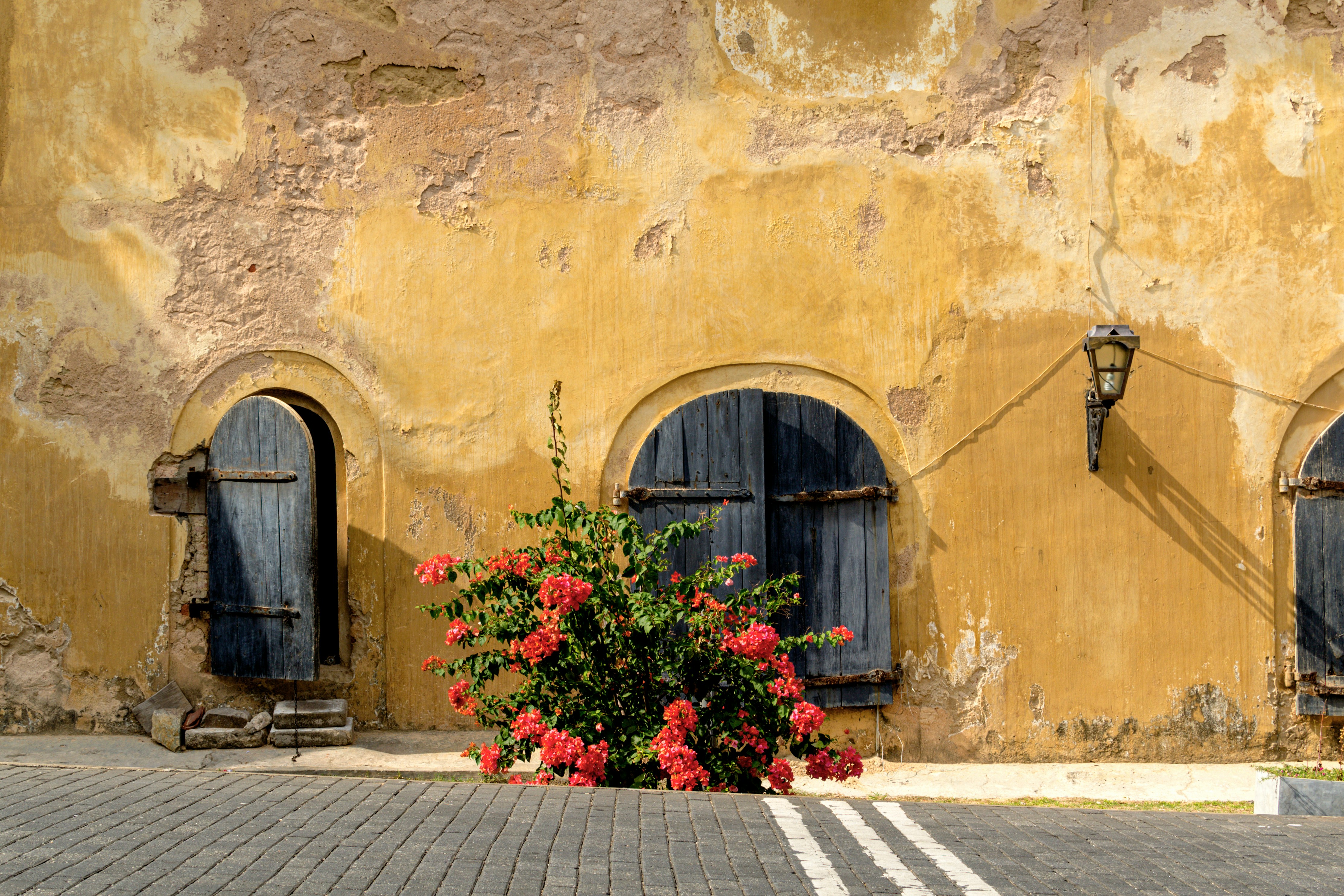 Colonial-era stonework with bougainvillea